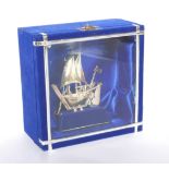 A modern 925 silver model of a sailing ship, 10cm high, in blue display case, 15.5 by 8 by 15cm