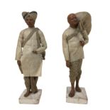 A pair of 19th century Indian Raj clay male figures, wearing traditional dress, both 25cm high