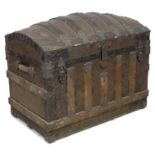 A 20th century dome topped storage chest, with wooden supports and embossed with metal decorative