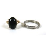 A platinum band, size R/S, 4.6g together with a 14ct gold black stone dress ring, size M, 2.4g