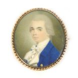 A yellow metal brooch with a portrait miniature of Regency gentleman