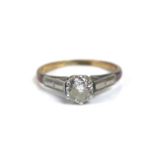 A 18ct gold diamond solitaire ring, the round cut diamond 4mm diameter, with illusion set shoulders,