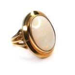 A modern 18ct yellow gold and opal dress ring, the oval cabochon opal in rubover setting, 17 by 12