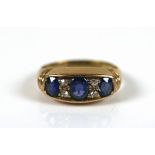 An 18ct gold sapphire and diamond ring, the largest oval cut sapphires approximately 3 by 4mm