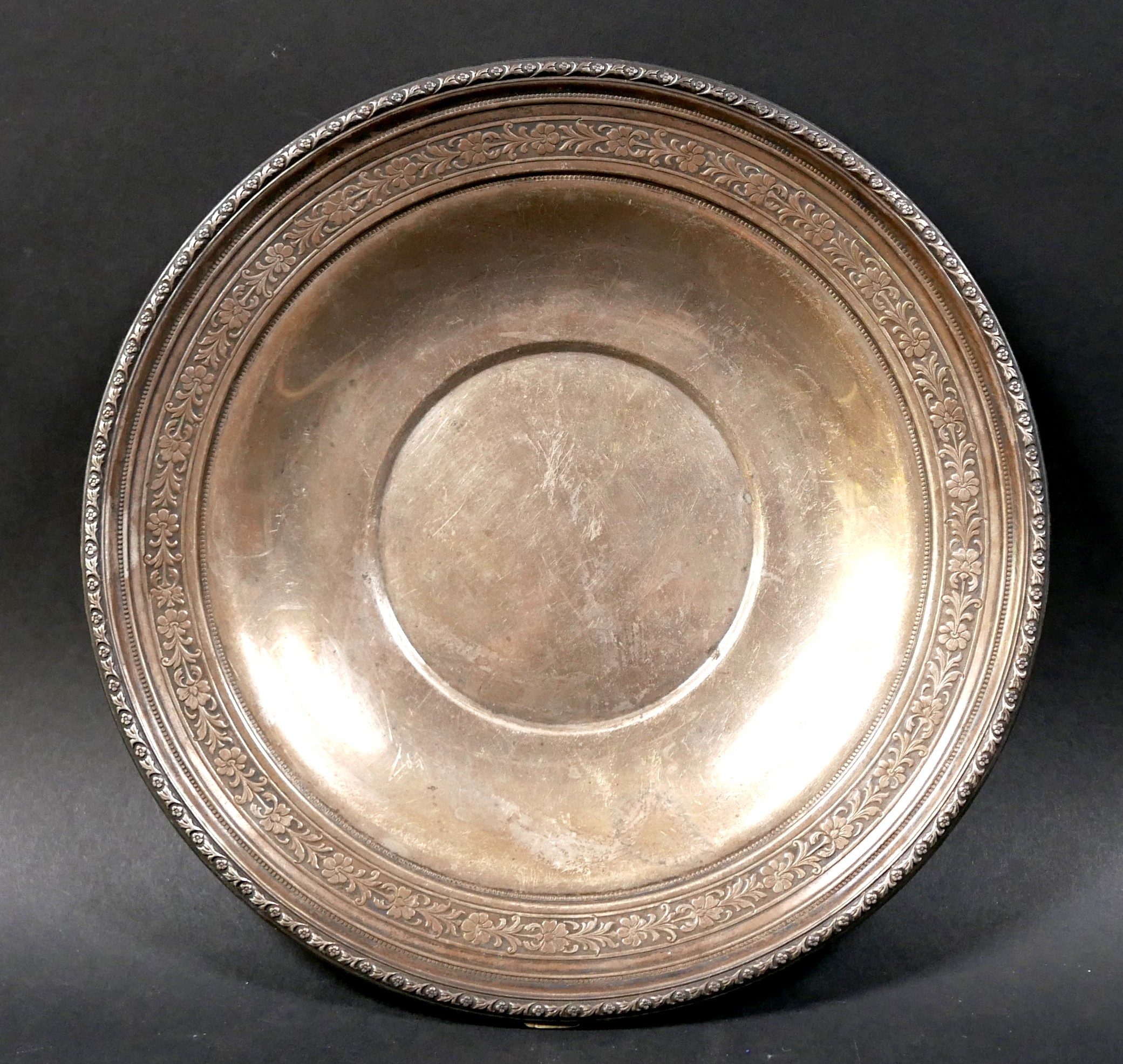 An American Sterling silver dish, circular form with cast floral decoration to the borders,