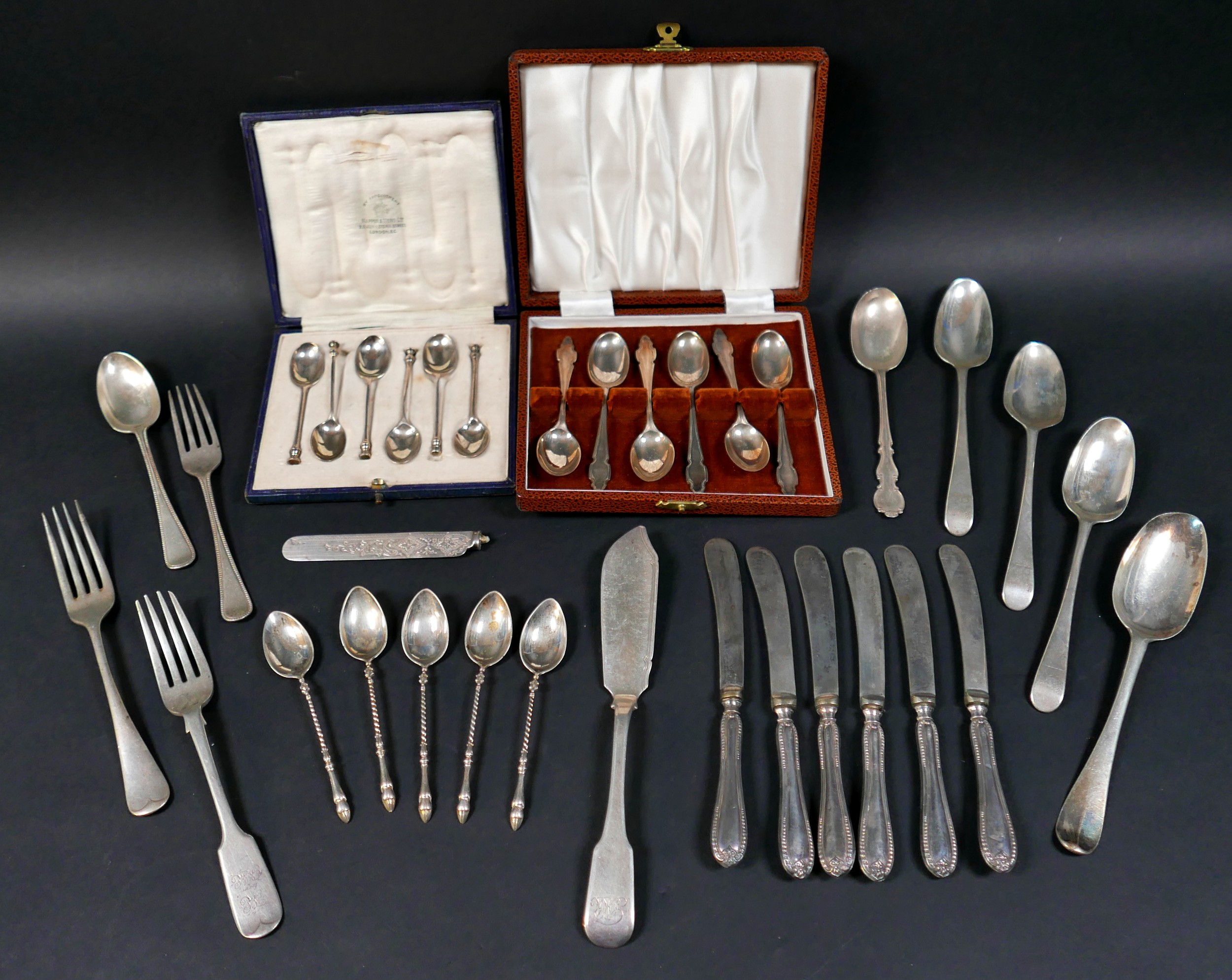 A group of mixed silver flatware, including two cased sets of coffee spoons, and a butter