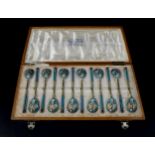A cased set of pre-revolution Russian enamelled teaspoons, with polychrome enamel decoration and