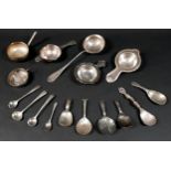 A group of mixed silver and white metal items, including caddy spoons, tea strainers, salt spoons, a