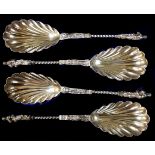 A cased set of four Victorian silver decorative serving spoons, with scalloped bowls, twist stems