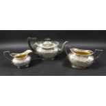A Victorian three piece silver tea set, comprising a teapot, 27 by 11 by 15.5cm high,milk jug and