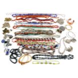 A collection of costume jewellery, mostly necklaces, with earrings, bangles and brooches. (1 bag)