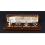 Four silver nautical menu holders by Harrods of London, two anchors, two ship's wheel, approximately