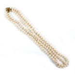 A double strand pearl necklace on a 9ct gold clasp, each pearl 6.2mm, 43cm total length, 38.8g.