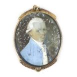 A yellow metal pendant with a portrait miniature of a Regency gentleman