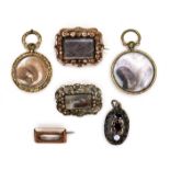 A group of gold and yellow metal memorial jewellery, comprising two round lockets, each inset with a