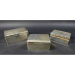 A group of three Edwardian silver cigarette boxes, machine turned decorations to lid, with cedar