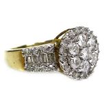 A 9ct yellow gold and diamond ring, of target form with wide tapering shoulders, set centrally