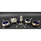 A group of George V and later silver, including four cauldron cruets, with blue glass liners, all