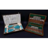 A George V silver and enamel dressing table set, comprising a mirror and four brushes with vintage