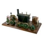 A live steam engine display layout, mounted to a wooden base, with Stuart horizontal single piston