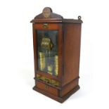 A Victorian Sovereign change machine 'W. H. Ell's Patent Safecheck', the mahogany cabinet with