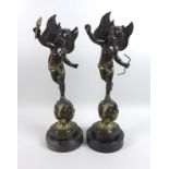 Two modern bronze sculptures, modelled as winged putti, cast in the Baroque style, one holding a