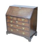 A 19th century oak bureau, with a small bank of drawers and cubby holes to its interior, brass