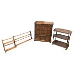 A group of of Ercol furniture, all with a dark stained finish, comprising two sets of wall hanging