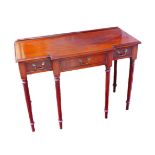 A 20th century breakfront mahogany sideboard, with three drawers raised upon reeded legs, 107 by