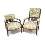 Two late Victorian mahogany armchairs, with similar decoration and cream and grey foliate