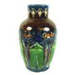 An Art Nouveau pottery vase, with stylised flowers incised into the body, over glazed in majolica