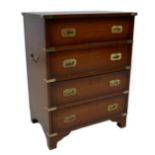 A reproduction chest of four drawers, in campaign chest style with brass corners and recessed