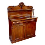 A Victorian mahogany chiffonier, with shaped backboard over a pair of cupboard doors each with a