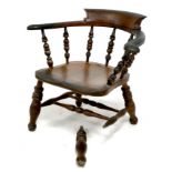 A 19th century oak smokers bow armchair, raised on turned supports, a/f poor condition leg detached,