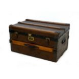 An Edwardian travelling trunk, wooden bound and leather effect covering, labelled inside 'H.