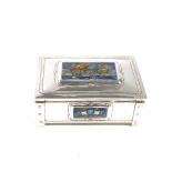 AN ARTS & CRAFTS SILVER AND ENAMEL MOUNTED TABLE CIGARETTE BOX OF NAVAL INTEREST