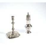 A GEORGE III SILVER SUGAR CASTER AND A VICTORIAN SILVER TAPER STICK (2)