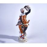 A MEISSEN FIGURE OF THE DANCING HARLEQUIN WITH A MUG