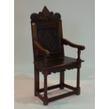 A 17TH CENTURY STYLE CARVED OAK WAINSCOT CHAIR