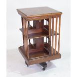 AN EDWARDIAN INLAID MAHOGANY REVOLVING BOOKCASE