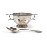 A SILVER TWIN HANDLED CHRISTENING BOWL AND SPOON