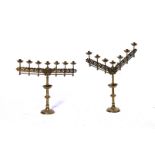 A PAIR OF GOTHIC REVIVAL POLISHED BRASS SEVEN-LIGHT CANDELABRA