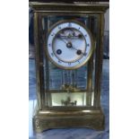 A FRENCH ENGRAVED BRASS FOUR GLASS TABLE REGULATOR CLOCK