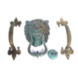 A GILT-METAL LION MASK DOOR KNOCKER AND A PAIR OF DOOR HANDLES (3)