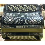 MAUGEIN FRERES; A BLACK BAKELITE AND DECORATED ACCORDION
