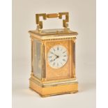 A FRENCH GILT BRASS STRIKING AND REPEATING CARRIAGE CLOCK