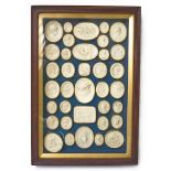 A FRAMED GROUP OF THIRTY-SIX ITALIAN PLASTER INTAGLIO IMPRESSIONS