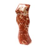 A SCULPTED RED MARBLE FEMALE TORSO