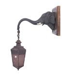 A PATINATED BRONZE ELEPHANT HEAD HANGING WALL LIGHT