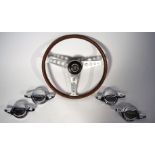 FOUR VINTAGE CHROME JAGUAR SPINNER CAPS AND A 1960’S LES LESTON WALNUT AND ALUMINIUM STEERING...